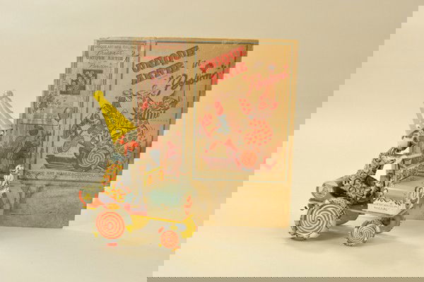 "UNIQUE ARTIE" CLOWN CAR: Unique Art, zany clockwork lithographed tin car carries extremely colorful clown on wacky ride when activated, JoJo the dog sits on hood, includes original box, though tattered somewhat. 7 1/2" l.