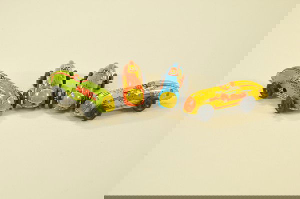 SET OF FOUR CAPTAIN MARVEL CARS: Automatic Toy Co., key wind operation, popular comic book hero portrayed on each side, cars numbered one through four. 4" l. each.