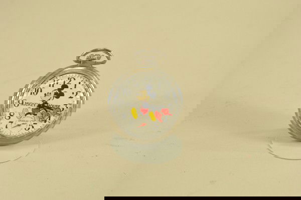 MICKEY MOUSE POCKET WATCH: Bradley, later edition, plastic face, chromed case, Mickey at center with arm dials, works well. 2" diam.