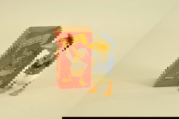 DONALD DUCK SCHUCO WALKER WITH BOX: Germany, Mickey Mouse Ltd., early tin version wind-up toy, wears felt jacket and hat, cast iron web feet, box missing flap on one side, tear at side. 6" h.