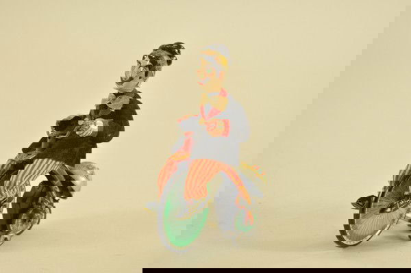 CLOWN ON TRICYCLE: TPS, Japan, lithographed tin, wears felt costume, clockwork driven, depicted on circus styled performing tricycle, well detailed with ringing bell. 6 1/2" h.