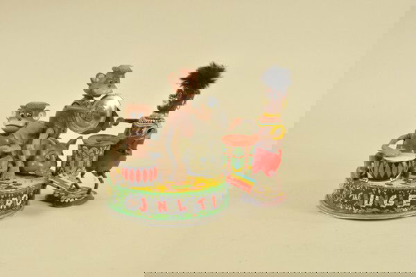 TWO JUNGLE THEME TIN TOYS: Lithographed tin, includes Marx Native playing drum, and Jungle Trio battery-op monkeys and elephant band. 7 1/4" h.