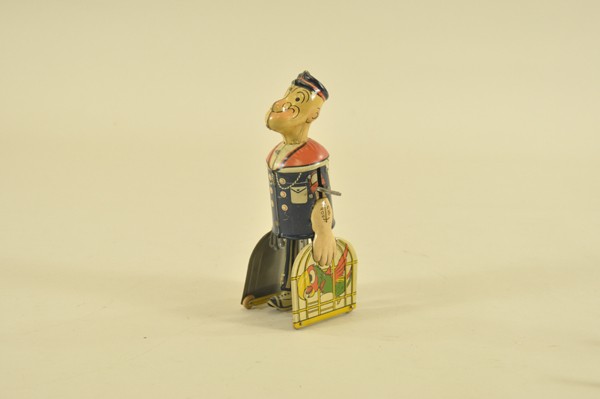 POPEYE CARRYING PARROT CAGES: Chein, lithographed tin figure of Popeye the Sailor with cages at sides containing graphic image of parrots, key wind operated. 8" t.