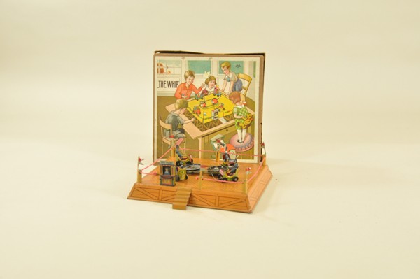 THE WHIP TOY: Germany, very scarce example with nice box lid, lithographed tin, features four open cars with seated passengers, clockwork driven, table top elevated base with flag poles and stairs by "Pay Here" tic
