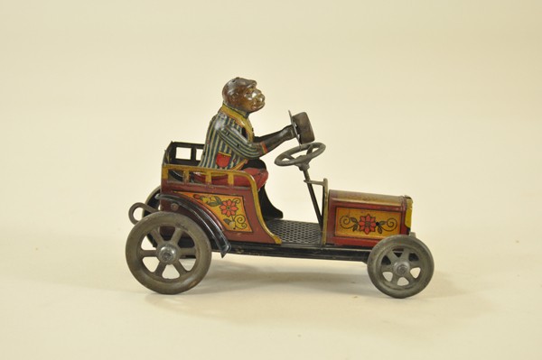 DISTLER MONKEY DRIVING AUTO: Germany, whimsical toy portrays monkey who tips hat while driving auto, clockwork mechanism, lithographed tin done in colorful graphic images. 6 1/4" l.