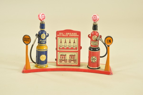 BRIGHTLITE FILLING STATION: Louis Marx, c. 1940's, lithographed tin gas station w/two gas pumps containing glass globes that light, center display case depicts oil bottles & cans, in and out signs on corners, all mounted on curv