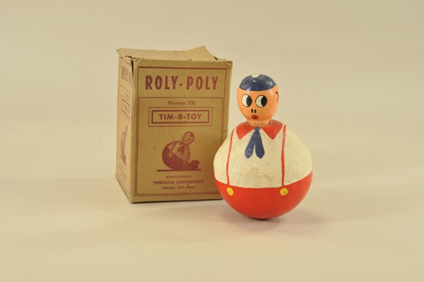 TIM-B-TOY ROLY POLY WITH BOX: Charming papier mâché roly poly boy with hand painted features, large eyes are side-glancing, giving a surprised look on face. 7 3/4" h.