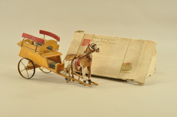 PONY WITH WOODEN CART: Early wooden wagon with nail construction, double bench seats and drop down gate is pulled by pinto horsehide covered pony with wooden wheels and leather harness, glass eyes add to overall appeal, mak