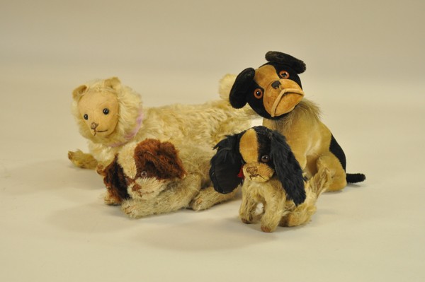 LOT OF FOUR EARLY STUFFED PLUSH DOGS: Largest is a fully jointed white mohair dog with felt covered face, "shoe button" type eyes, stitched nose and mouth, and pointed felt ears with minor hole in left ear; bulldog with swivel neck, two-t