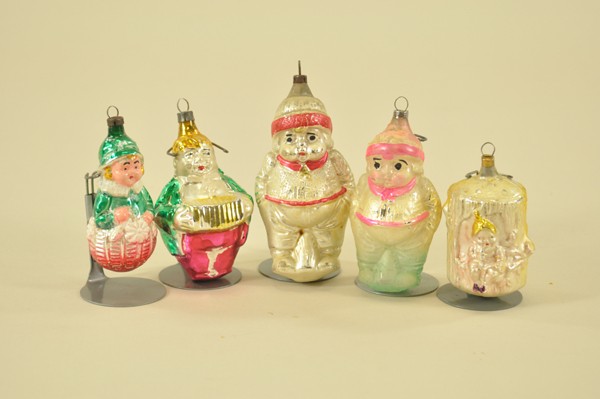 FIVE ASSORTED CHILDREN ORNAMENTS: Includes two chubby boys, fat man playing concertina, girl in flower basket and elf on tree stump, hand painted glass ornaments. 2 1/2"-4 1/4".