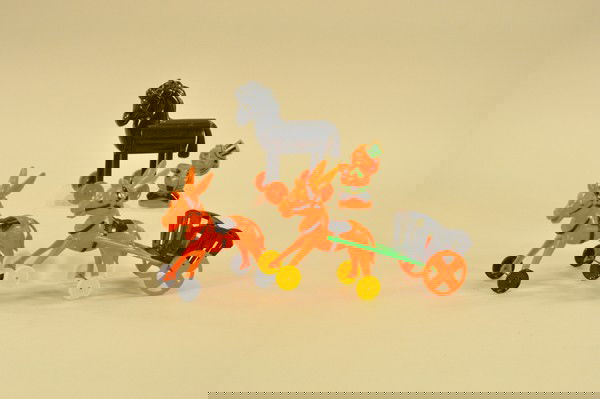 LOT OF FOUR HALLOWEEN PLASTIC TOYS: Includes hard plastic examples: one pirate (chipped ear), wheeled black horse, two donkeys and an interchangeable cart; a very colorful lot. 3"-9.