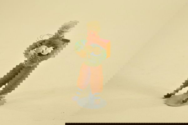 SPUN COTTON CHILD WITH BACK PACK ORNAMENT: Germany, composition face, spun and pressed cotton, this child has school back pack and is carrying three snowballs. A very colorful Christmas tree decoration. 5" t.