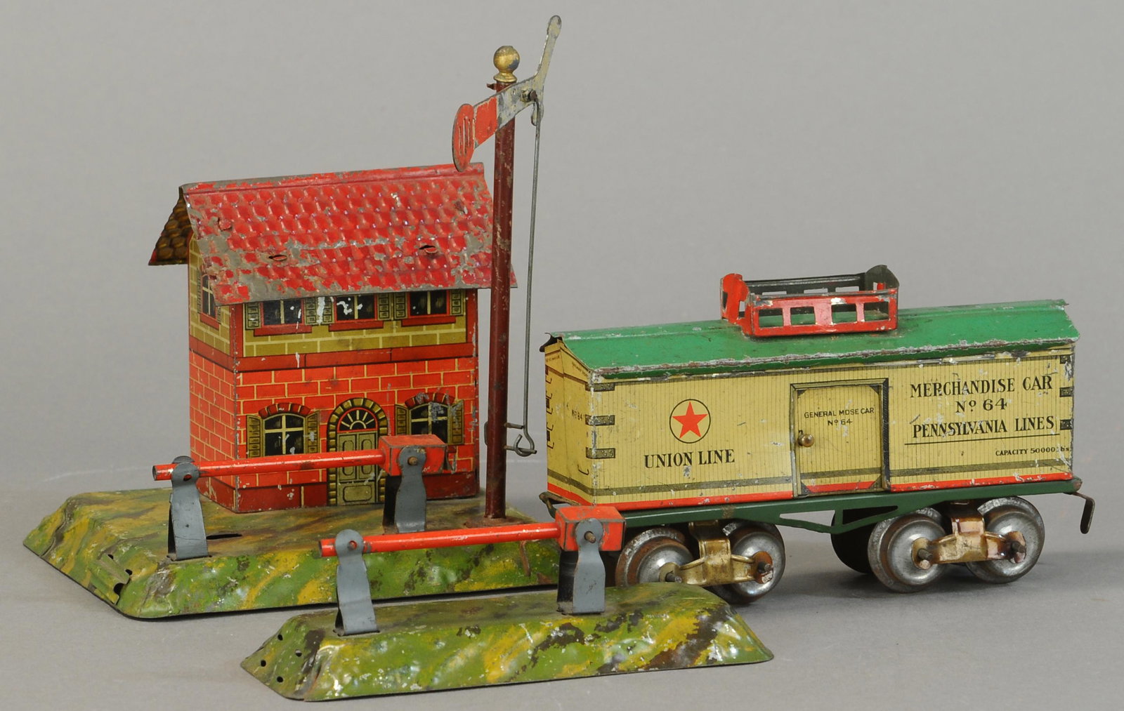 IVES BOX CAR & CARETTE CROSSING: 27. IVES BOX CAR & CARETTE CROSSING | O gauge, litho. | Box car 6" l. | Box car missing one door and has caboose roof added. | $300 - $600