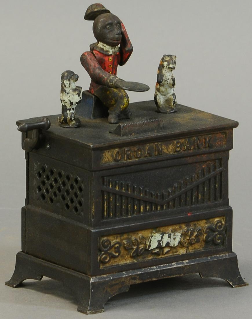 ORGAN GRINDER BANK - DOG & CAT: 126. ORGAN GRINDER BANK - DOG & CAT | Crack on top and bottom plate, otherwise All Original Condition. | $200 - $400