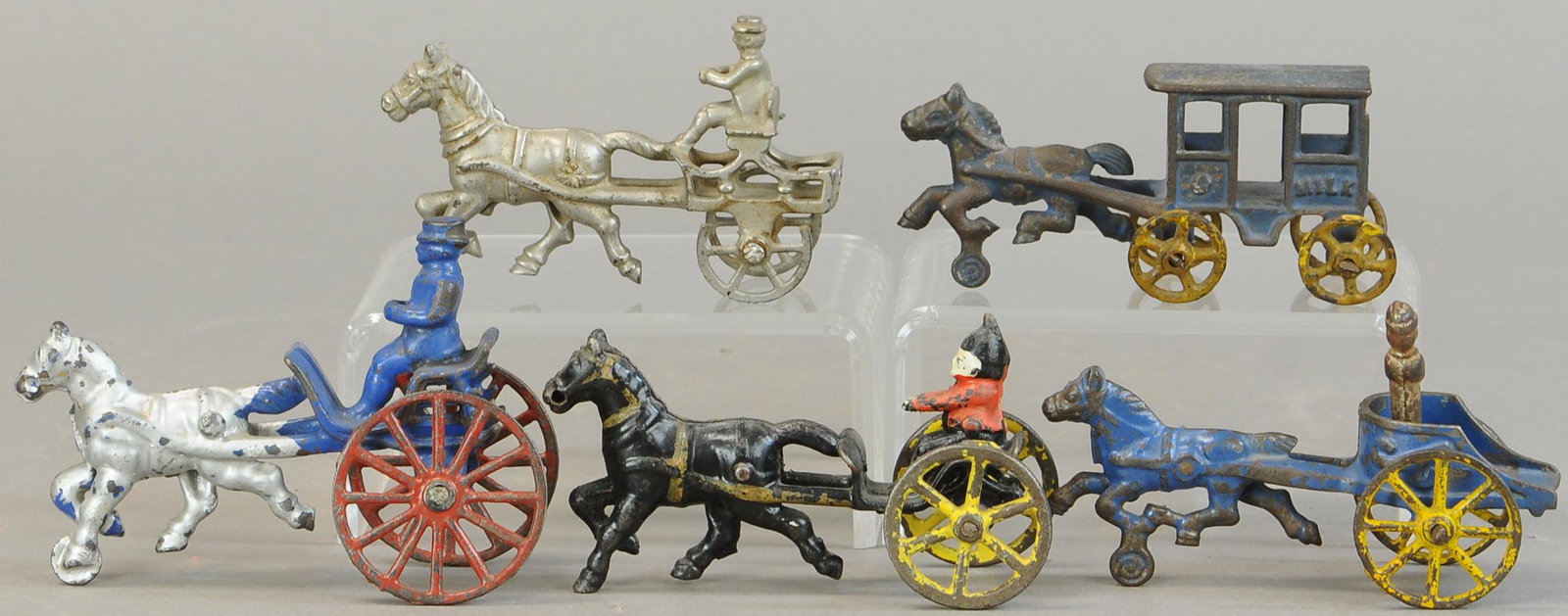 FIVE SMALL HORSE DRAWN WAGONS: 266. FIVE SMALL HORSE DRAWN WAGONS | 5.5" l. | Small Shimmer cart has part of one wheel missing, otherwise All Original Condition. | $250 - $500