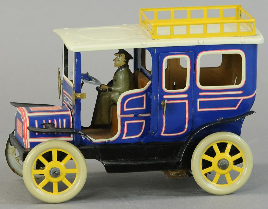 MEDIUM HANS EBERL LIMOUSINE: 118. MEDIUM HANS EBERL LIMOUSINE | 7" l. | Spring is active but bent, car is repainted, driver is original. | $200 - $400