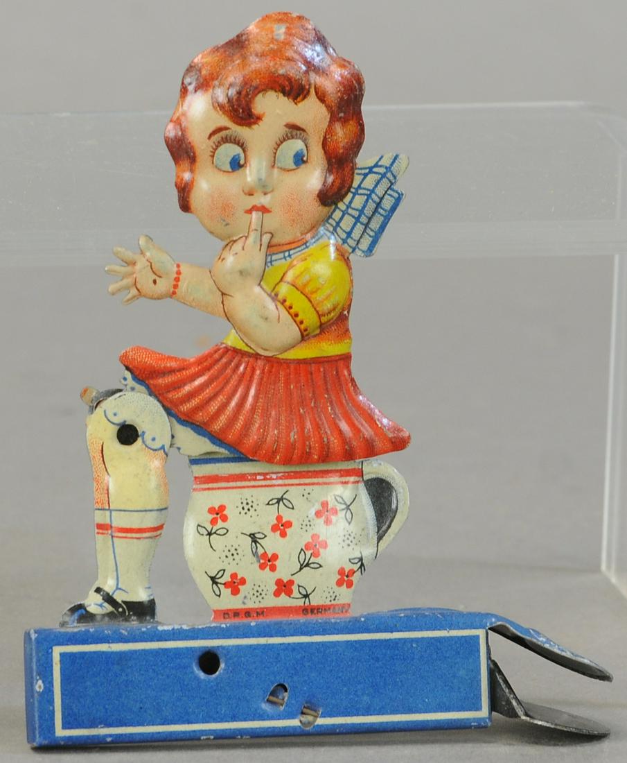 GELY GIRL ON RAT POT TOY: 137. GELY GIRL ON RAT POT TOY | 5" h. | All Original Condition. | $100 - $200