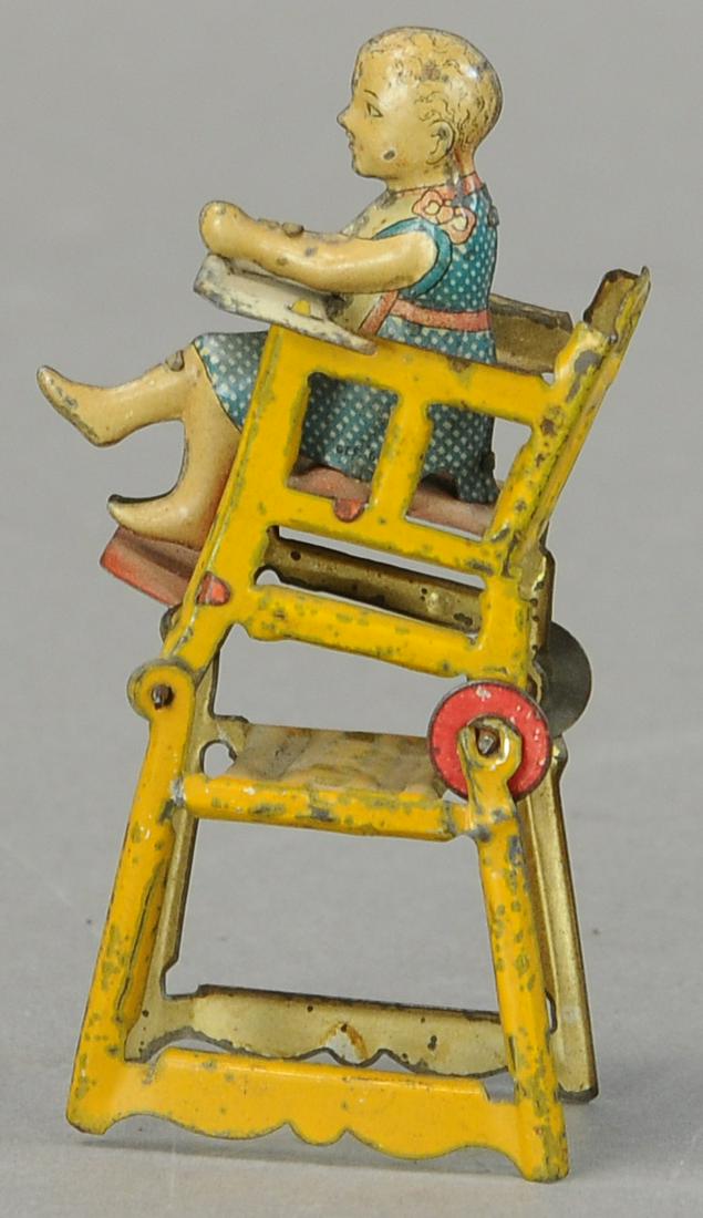 MEIER CHILD IN HIGH CHAIR PENNY TOY: 144. MEIER CHILD IN HIGH CHAIR PENNY TOY | 3.5" h. | Missing child's tray, otherwise All Original Condition. | $40 - $80