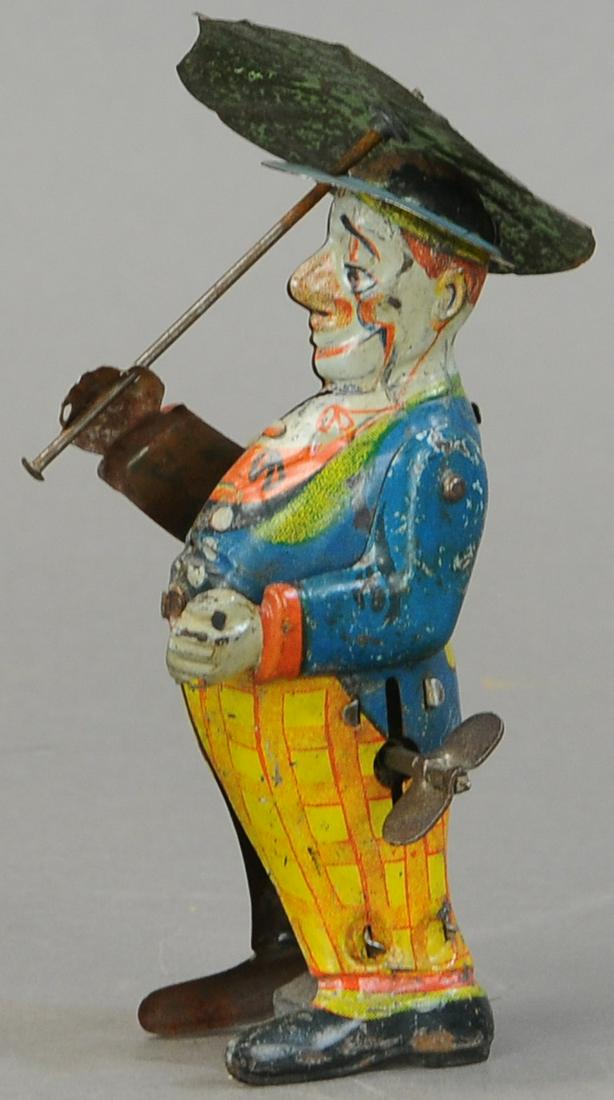 GERMAN CLOWN SPINNING UMBRELLA: 169. GERMAN CLOWN SPINNING UMBRELLA | 5.5" h. | Working in All Original Condition. | $200 - $400