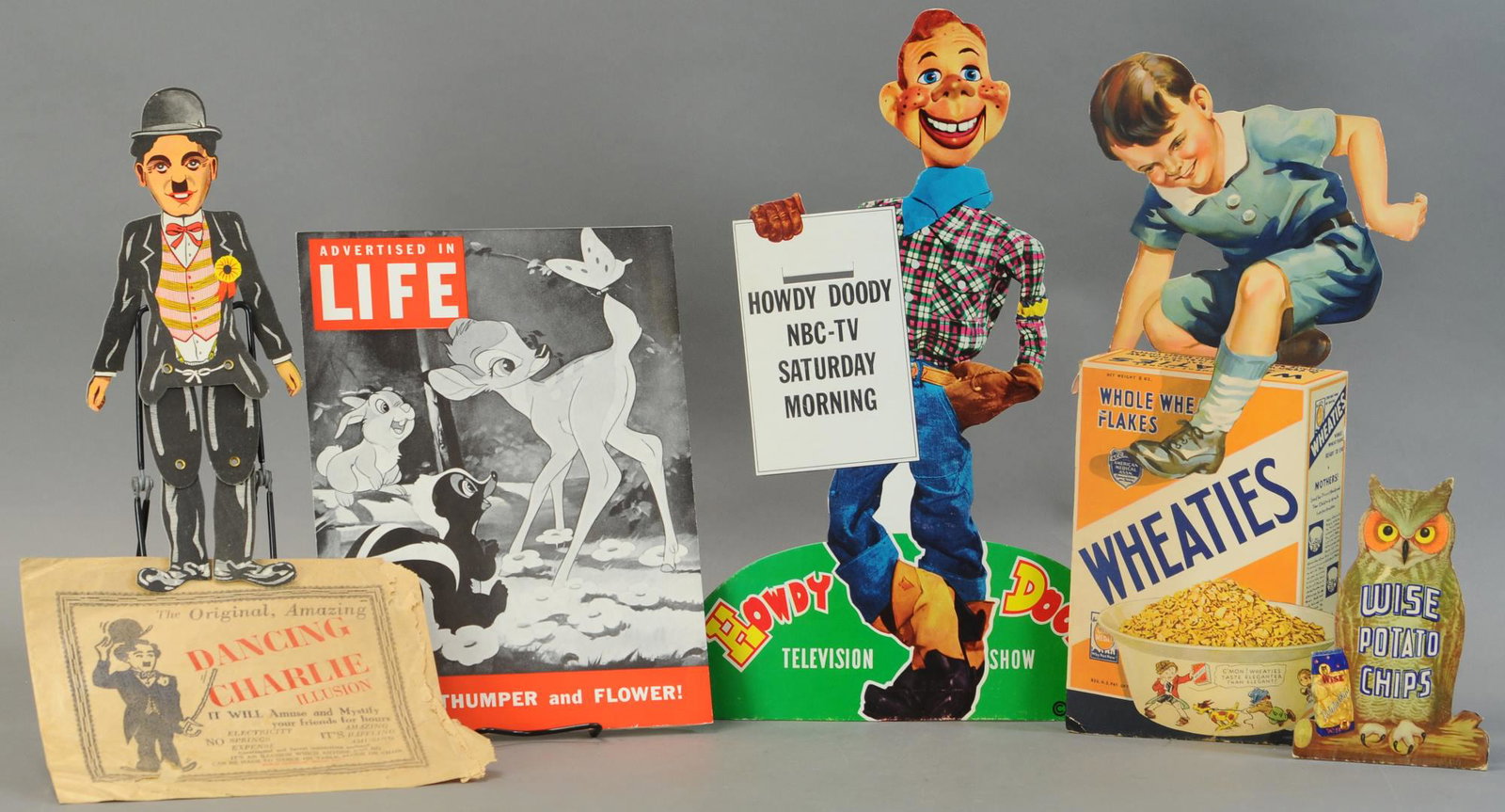 GROUPING OF CARDBOARD ADVERTISEMENTS: 410. GROUPING OF CARDBOARD ADVERTISEMENTS | 20" h. | All Original Condition. | $200 - $600