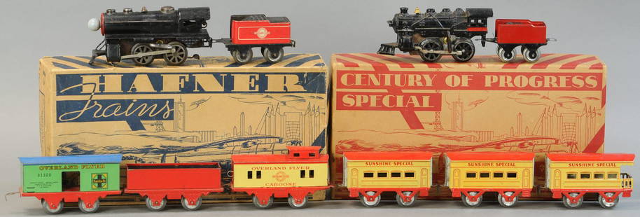 BOXED HAFNER TRAIN SETS: 18. BOXED HAFNER TRAIN SETS | 0 Gauge. | Provenance: Paul Cole Collection. | Loco 6.5" l. | Tear to lid of blue box and distressed, touch-up to tinplate loco, in (Exc - Pristine Cond.) | $150 - $300