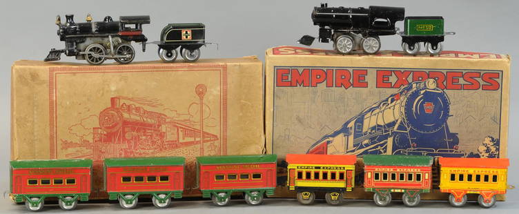 BOXED HAFNER PASSENGER SETS: 19. BOXED HAFNER PASSENGER SETS | 0 Gauge. | Provenance: Paul Cole Collection. | Loco 6" l. | Tear to colored box lid, brown box distressed, one Empire Express coach has damaged coupler, overall in (V