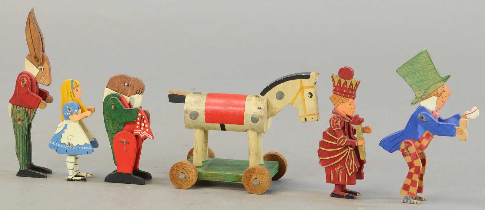 ALICE IN WONDERLAND TALFOURD TOYS: 312. ALICE IN WONDERLAND TALFOURD TOYS | Also included a wooden horse toy. | Provenance: Paul Cole Collection. | 5" h. | (Exc. Cond.) | $200 - $400