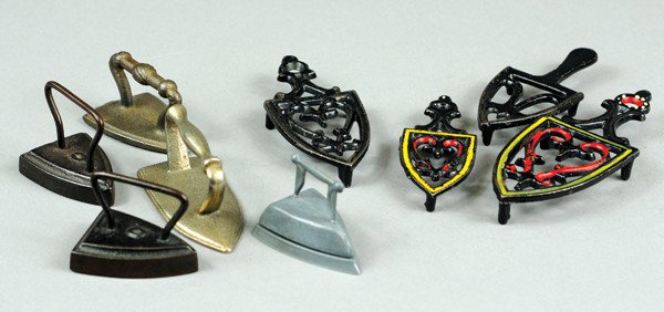 GROUPING OF TRIVETS AND CHILDREN'S SAD IRONS: All cast iron, and one done in pewter, includes two trivets with hand painted highlights. 1 7/8" to 4 1/2" l.