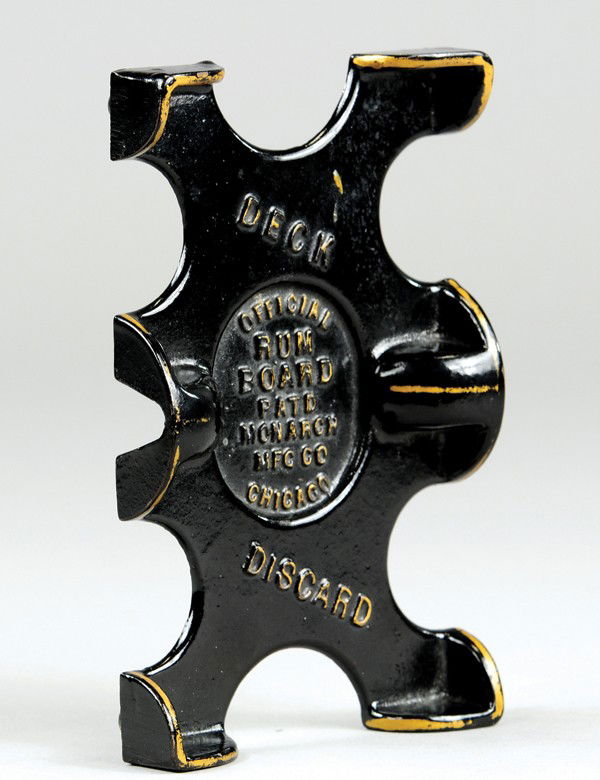 CAST IRON PLAYING CARD HOLDER: Painted in black, gold trimmed, embossed "Official Rum Card, Deck, Discard" on front. 4" x 6 1/4".