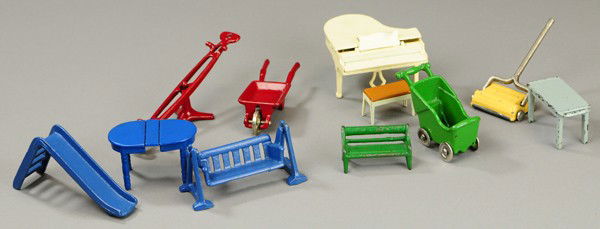 GROUPING OF KILGORE MINIATURE FURNITURE: Cast iron, each piece painted, includes table, sweeper, see-saw, bench, rocking love seat, sliding board, carriage, side table and wheelbarrow. 2" to 4 1/4" l.