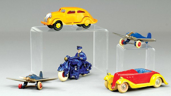 CAST IRON TOYS AND AIRFLOW VEHICLE: Lot includes Kilgore Bluestreak in red, yellow and blue, two nickel wing airplanes, Champion Solo Cop cycle and pressed steel Wyandotte air flow in orange. 4 3/4" to 5 3/4" l.