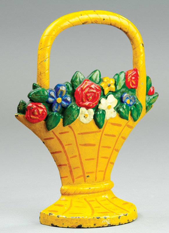 MIXED FLOWERS IN BASKET DOORSTOP: Hubley, cast iron, yellow painted basket with brown accents simulating wicker design, colorful bunch of flowers. 10 3/8" h.