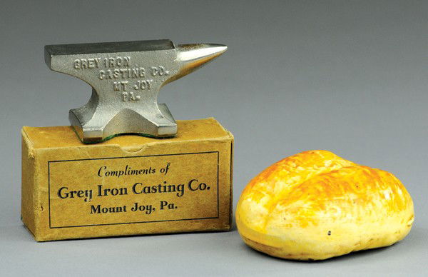 HUBLEY AND GREY IRON CO. PAPERWEIGHTS: Features nickel cast iron anvil embossed Grey Iron Casting Co., and loaf of bread figural weight with the Hubley Co. name on base, includes box for Grey Iron. 3 1/2" l.