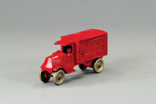 DENT MACK CARGO TRUCK: Cast iron, painted in red overall, driver cast at window, body has embossed sides to simulate panel sides. 6" l.