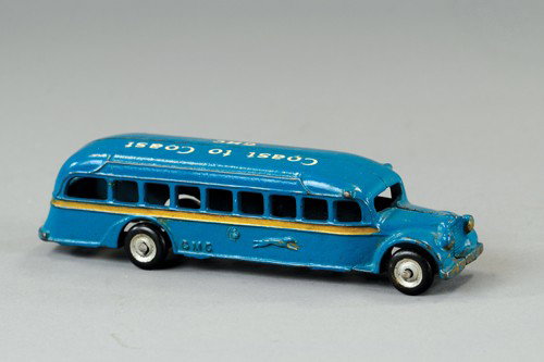 ARCADE GMC GREYHOUND BUS: Stenciled "Coast to Coast GMC" on roof, cast iron, painted in blue body, gold side striping, rubber tires. 7 1/2" l.