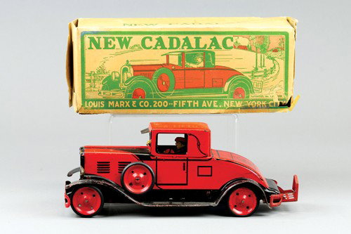 *MARX BOXED "NEW CADILLAC": Lithographed tin, done in red overall, black fenders, seated driver, spare on running board, foldable luggage rack. 11" l.