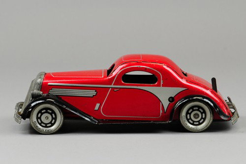MARX COUPE: Lithographed red in heavy tinplate, black fenders, nickel finish grille and bumper, clockwork driven, lever on trunk. 12" l.