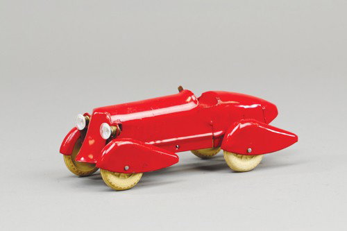 WYANDOTTE RACER WITH LIGHTS: Pressed steel, 30's open racer with deco styling, full fenders, painted in red, electric headlights. 8 1/2" l.