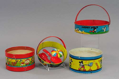 MICKEY MOUSE SAND SCREENS AND DRUM TOYS: Walt Disney characters appear on these lithographed tin beach and drum toys, very colorful, one screen includes sand molds. 6 1/2" - 8" dia.
