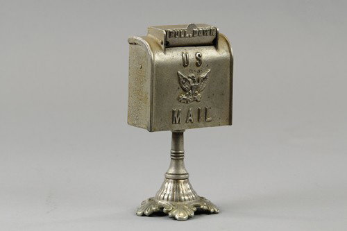 U.S. MAIL ON PEDESTAL: Hubley, nickeled cast iron, billed as the Victorian base, scarce example with embossed lettering and Eagle on front, pull down panel for coin slot. 7 3/4" h.