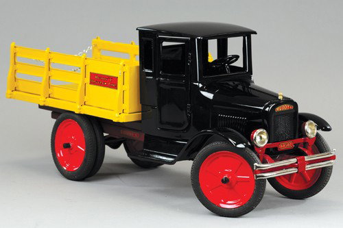 BUDDY 'L' BAGGAGE LINE TRUCK: C. 1932, doored cab design, painted in black with yellow stake body, red disc wheels, rubber tires, professional restoration to all original toy, great look, nickel bumper, side decals, dual rear whee