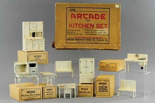 ARCADE BOXED KITCHEN SET: Several appliances include Hot Point electric range, Kitchen Boone cabinet with miniature food items, Kohler electric sink, Curtis dining alcove with table, Frigidaire and Boone table with one chair,