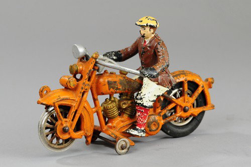 HUBLEY HARLEY DAVIDSON MOTORCYCLE WITH CIVILIAN RI: Cast iron cycle painted in orange, features elusive civilian figure in painted outfit, partial decal on tank. 9" l.