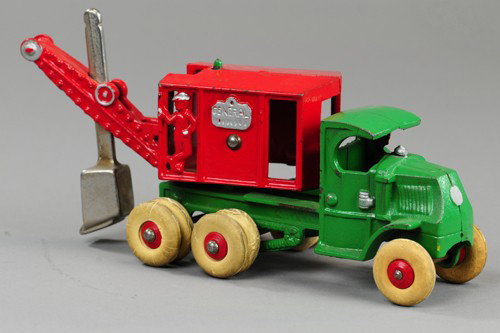 HUBLEY MACK TRUCK MOUNTED "GENERAL" DIGGER: Cast iron, Mack 'C' cab, painted in green, red steam housing, nickel shovel, rubber tires, driver cast in cab and rear doorway. 10" l.