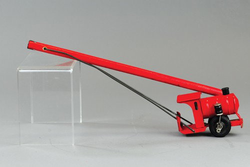 KINGSBURY TRAIN PUSH TOY: Pressed steel, painted in red overall, wood handles fold out for pushing toy along floor, articulated side pistons, rubber tires, scarce example. Train - 5", folded - 28".