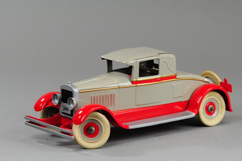 KINGSBURY TOWN CAR: Restored 1927 model, No. 344, pressed steel, painted in tan and red, rubber tires, spare on rear luggage rack, clockwork mechanism, opening rumble seat. 13 1/2" l.