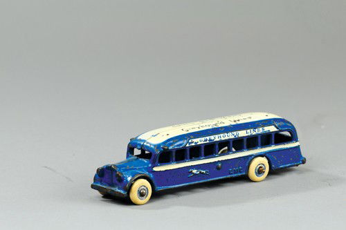 ARCADE GMC GREYHOUND BUS: Stenciled "Greyhound Lines" on roof, cast iron, painted in blue body, white roof and side stripe, Greyhound embossed on sides, rubber tires. 7 1/2" l.
