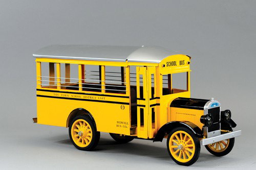 CONTEMPORARY NEW ERA SCHOOL BUS: Designed 1992, great detail, reads "Toy Town District East" on sides, a classic yellow and black school bus, very creative molding effects, mottling spared to tooling design, spoke wheels, rubber tire
