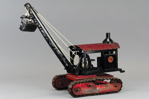 BUDDY 'L' CLAM DREDGE ON TREADS: Early circular decal, scarce example, heavily tooled, pressed steel construction toy, full treads, swivel housing with vertical boiler, hand cranking boom with clam shell, red frame and roof. 20" l.