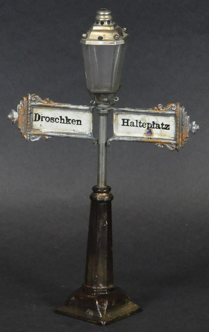 MARKLIN OIL LAMP W/ TAXI STOP SIGNAGE: 282. MARKLIN OIL LAMP W/ TAXI STOP SIGNAGE | Being sold by the nephew of the original owner. | 8.25" h. | (Exc. Cond.) | $2,000 - $4,000